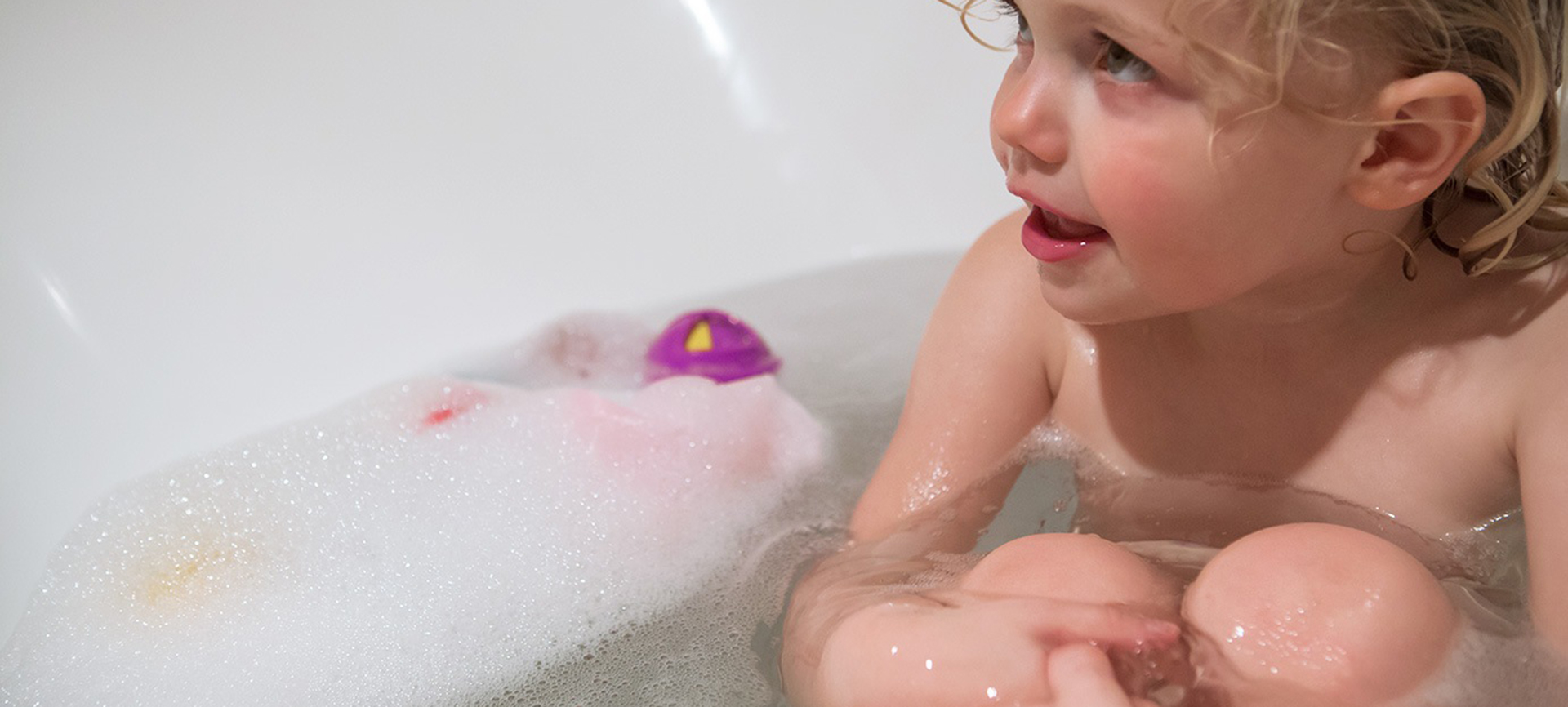 Toddler enjoying a hot bath heated with Trustpower's reticulated gas supply